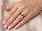 model A fine cluster ring featuring to the centre a round dark blue sapphire, 5mm diameter (0.50 carats) mille grain setting.
