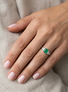moel A fine white gold* ring that features a rectangular emerald centre stone, measures 6x6.5mm (est one carat), mid to dark green hue, natural inclusions as with most emeralds.
