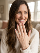 model A lovely white gold cluster ring. Features to the centre an oval white opal, 9x7mm, with an excellent play of colour.
