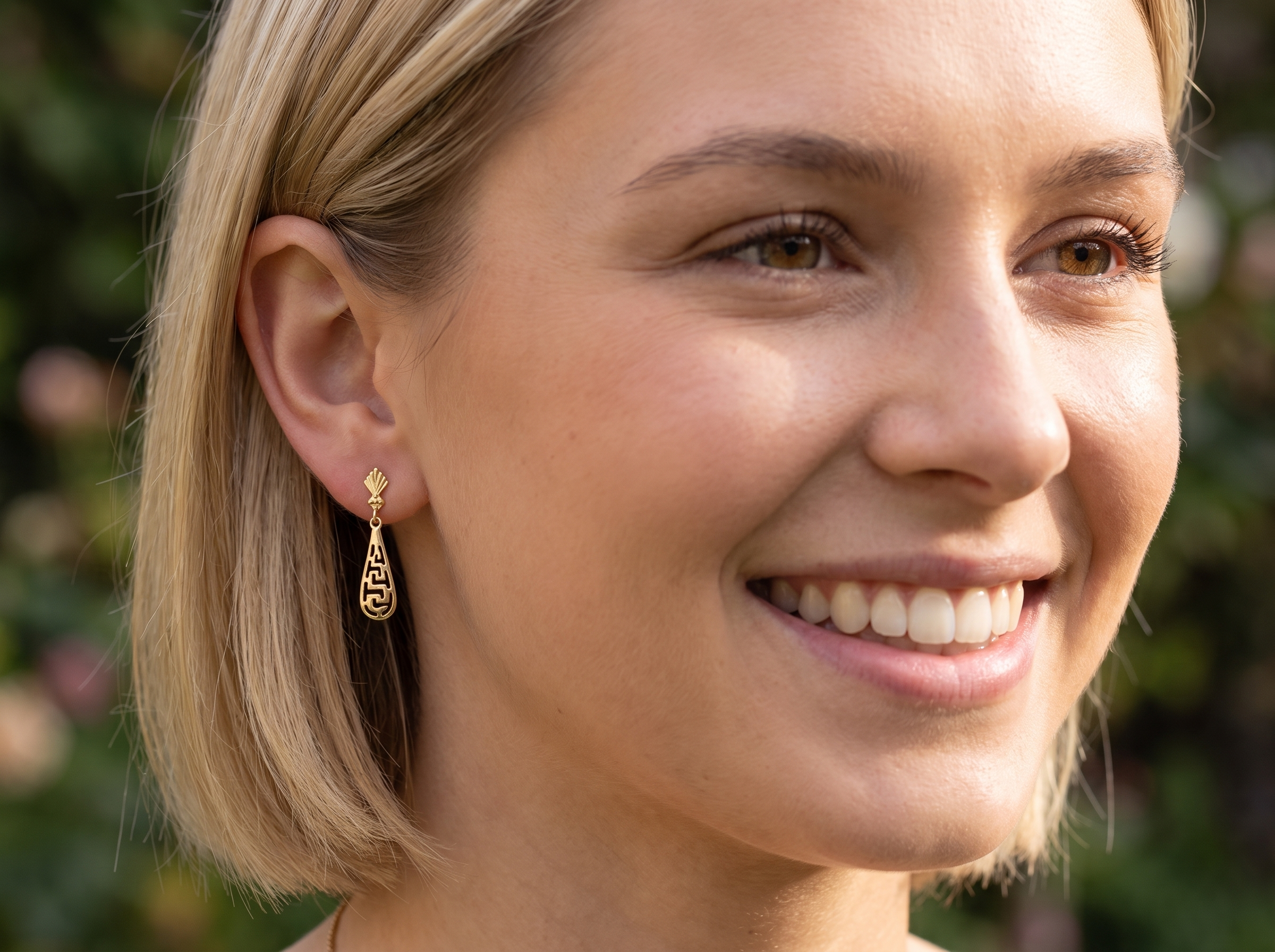 model A pair of 9 carat gold drop earrings. Each measures 25x10mm, celtic style