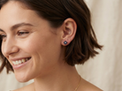 model A pretty pair of gold earrings each floral shaped with a small diamond centre stone surrounded by five petals, these round sapphires