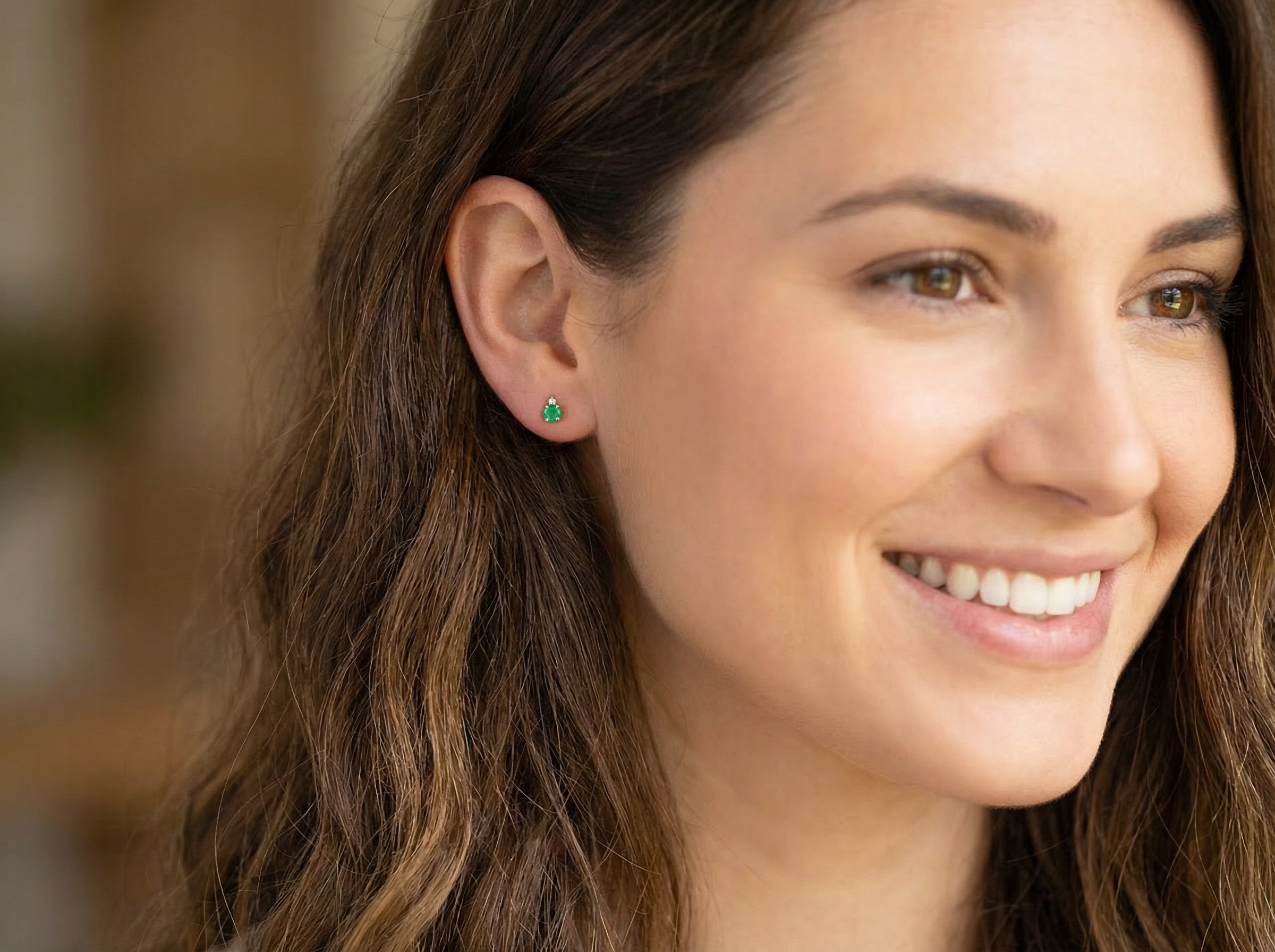 model A simple pair of 9 carat gold stud earrings. emerald and diamond