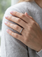 model An 18 carat white gold half hoop eternity ring. Mixed cuts of white diamonds which consist of seven round brilliant stones, each 2mm diameter and eight baguette cut stones, each 2x1.5mm. Estimated total 0.50 carats.