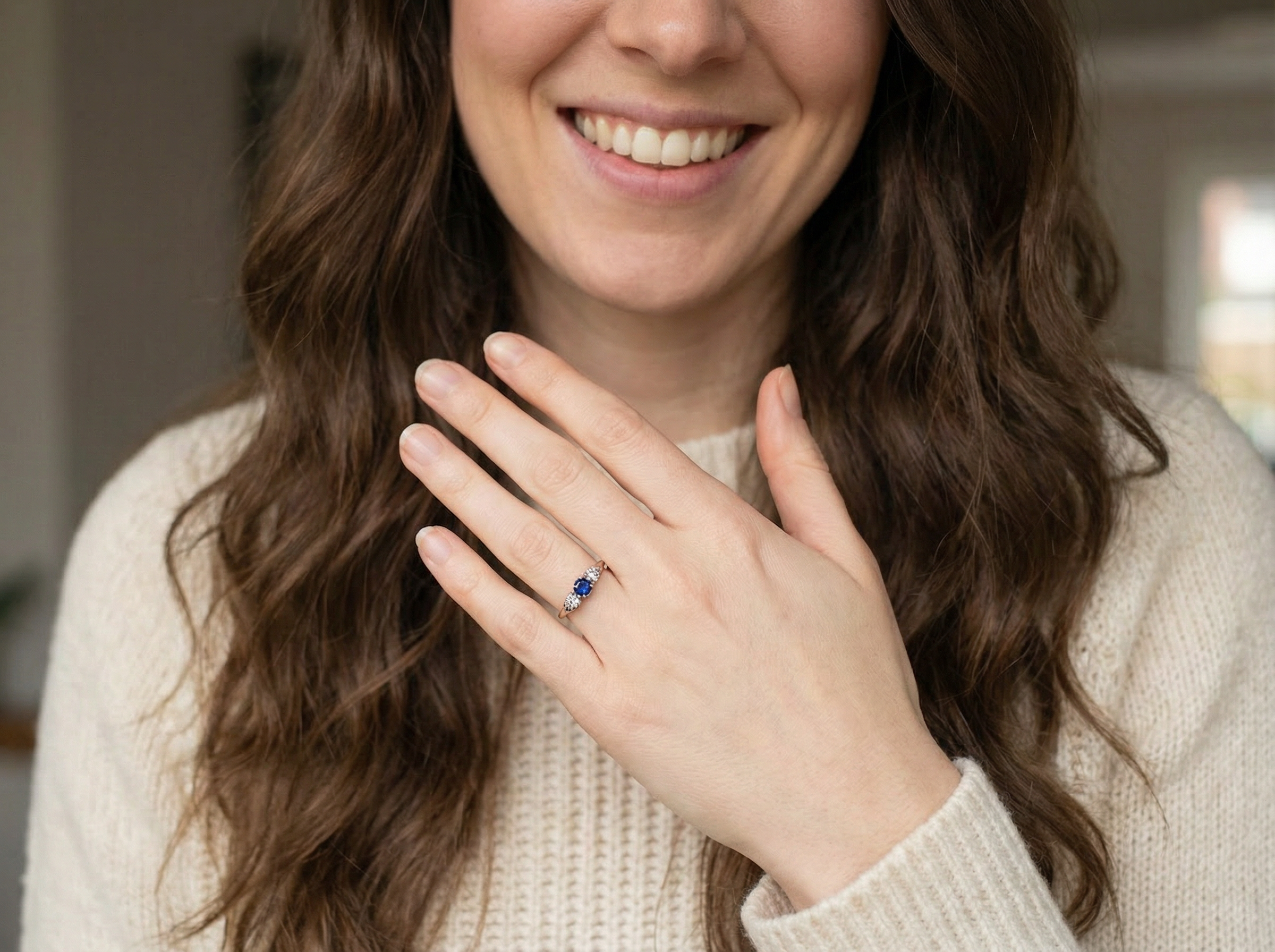 model An early 20th century engagement ring. The centre stone a dark blue sapphire