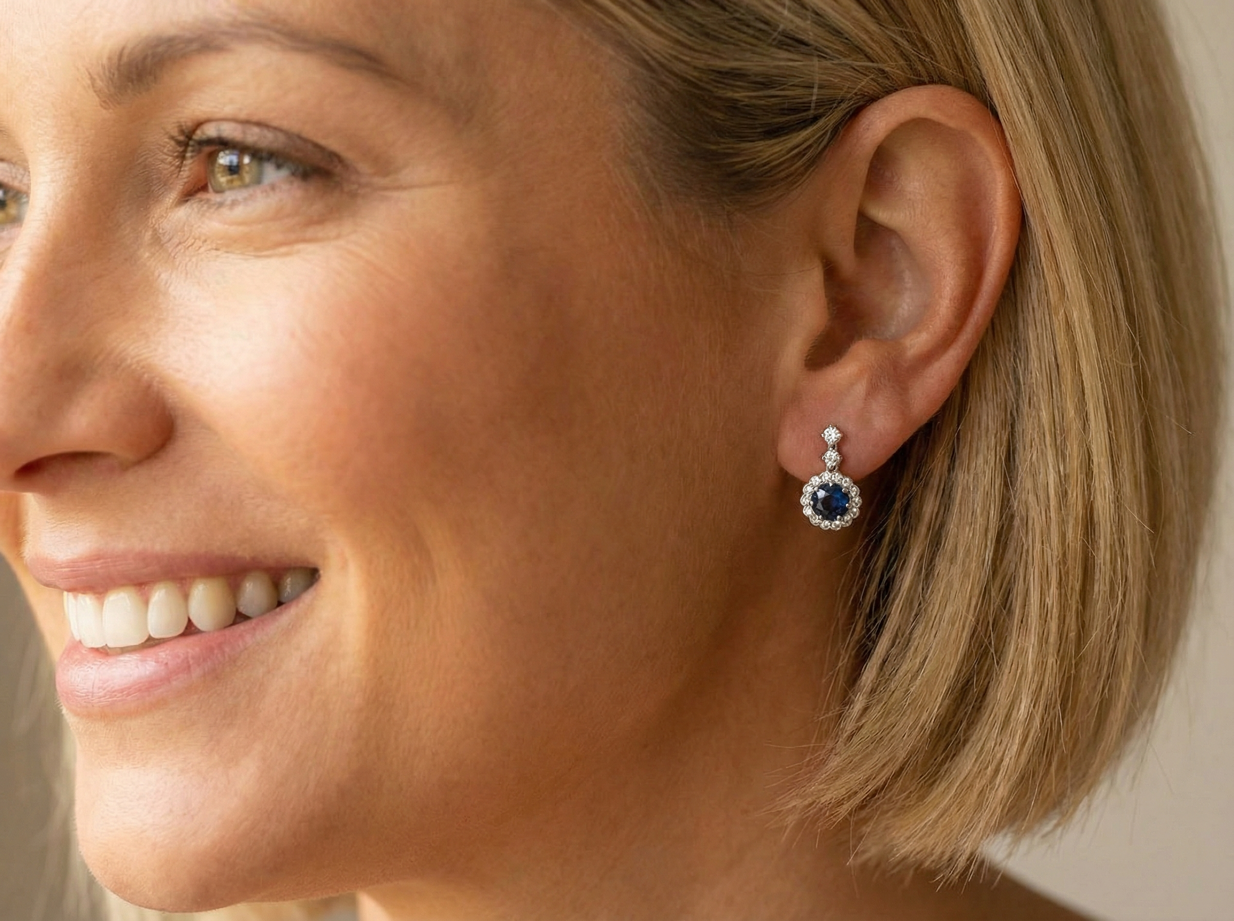 model An exquisite pair of drop earrings crafted in 18 carat white gold, each set with a striking inky blue-black sapphire measuring 7.5mm in diameter.