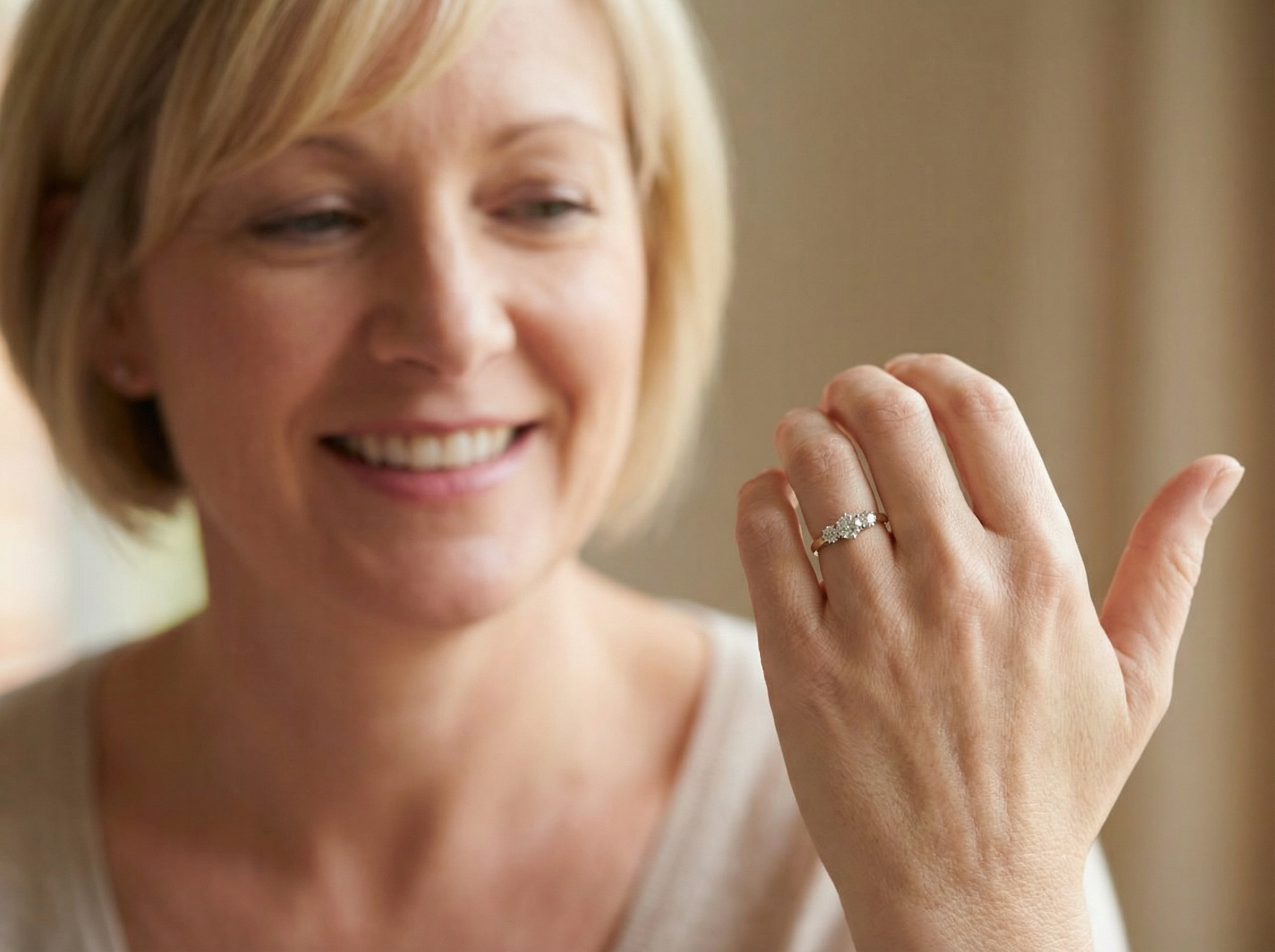 model The iconic trilogy ring. This example set with three fine brilliant cut white diamonds