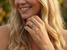 model  enchanting cluster ring that features at its centre an oval emerald, 