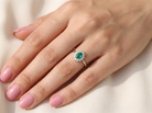 model white gold cluster ring.

Centre stone is an oval cut emerald, 6x3.7mm (just under 0.50 carats) good deep green hue.