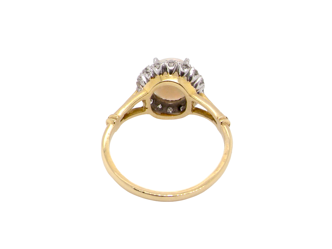 opal A vintage cluster ring. Features an oval white opal, measures 10x8mm, with a good play of colour.