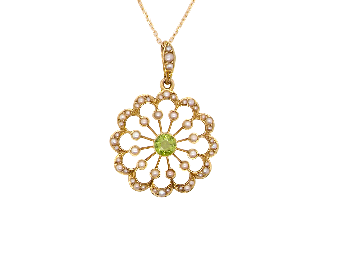 pendant from the Edwardian- Age of Elegance-

The centre stone- a round peridot 5mm diameter, mille grain set. A satellite perimeter of twelve seed pearls, each 2.4mm. The outside border is scalloped shaped 