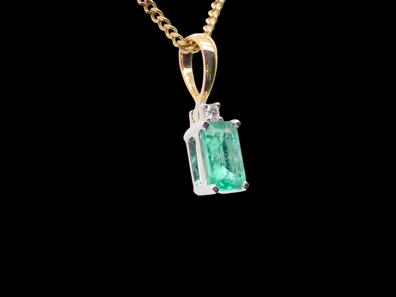 pendant set with a rectangular emerald 