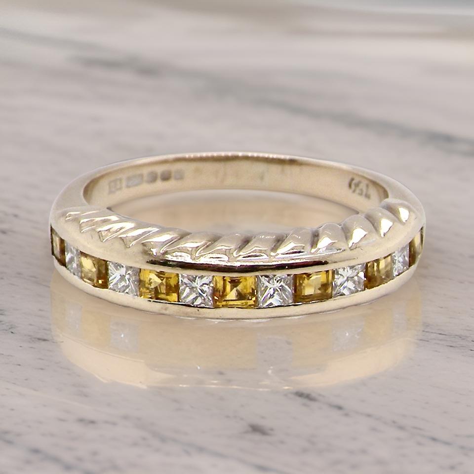 a fine yellow sapphire and diamond eternity ring