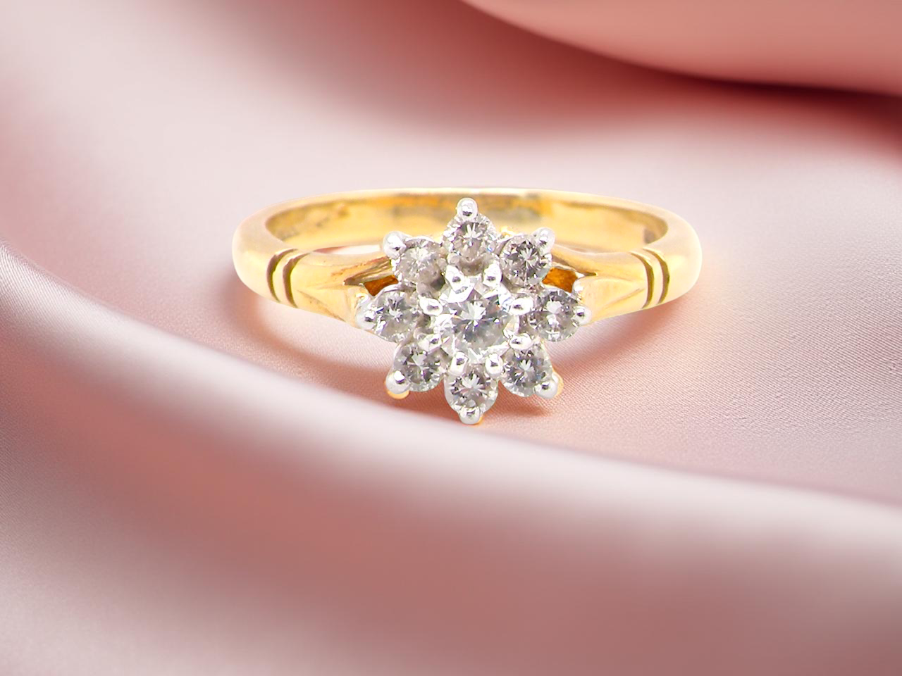 pretty cluster ring set with nine brilliant-cut white diamonds.
 A