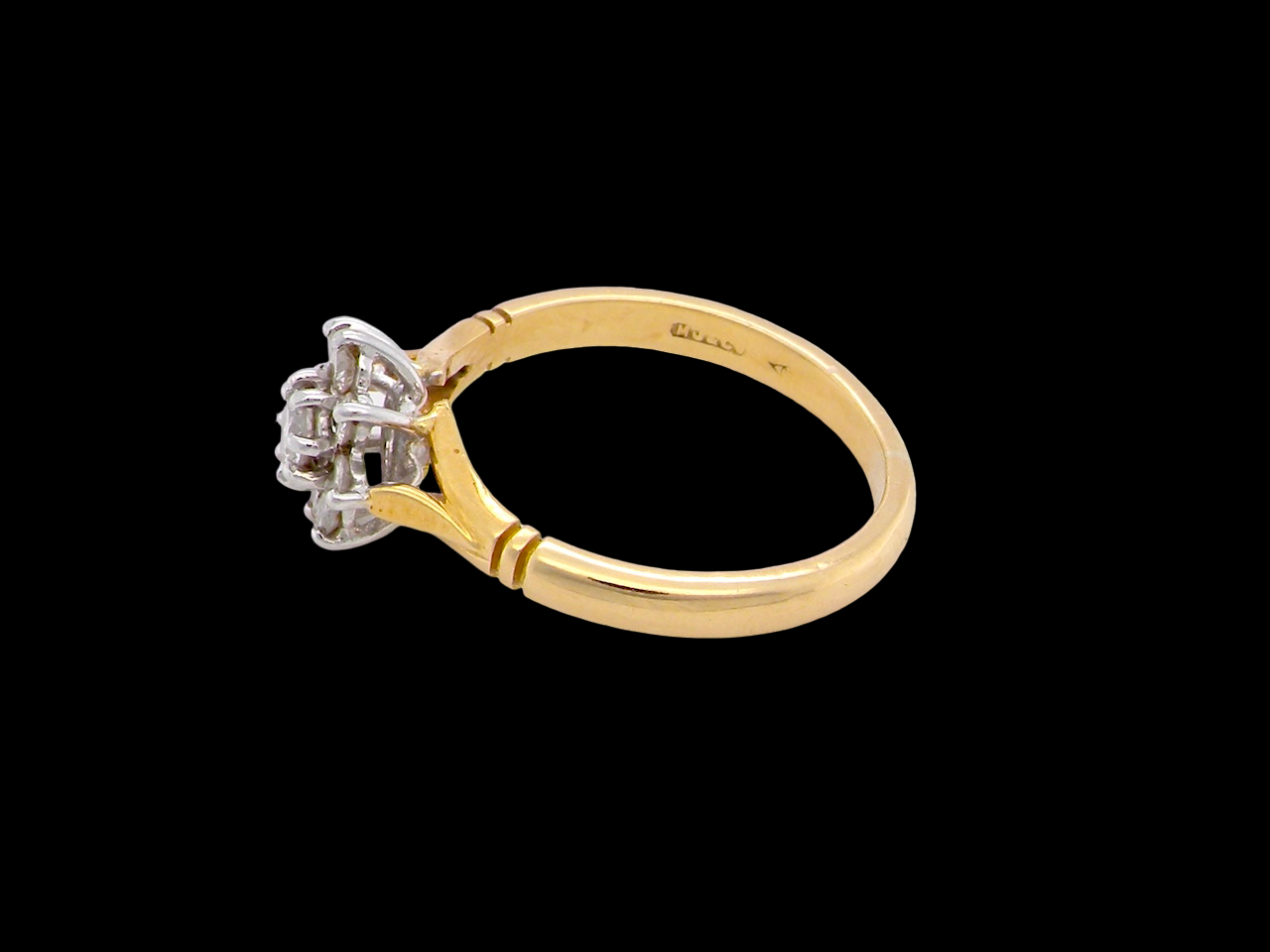 pretty cluster ring set with nine brilliant-cut white diamonds.
side
