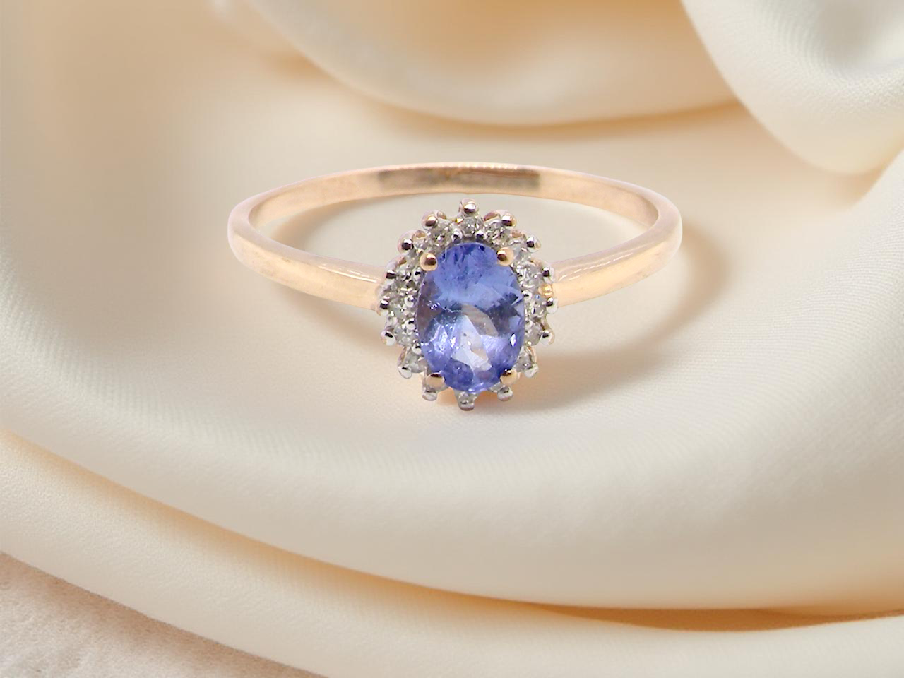 pretty cluster ring with  an oval cut tanzanite gemstone,