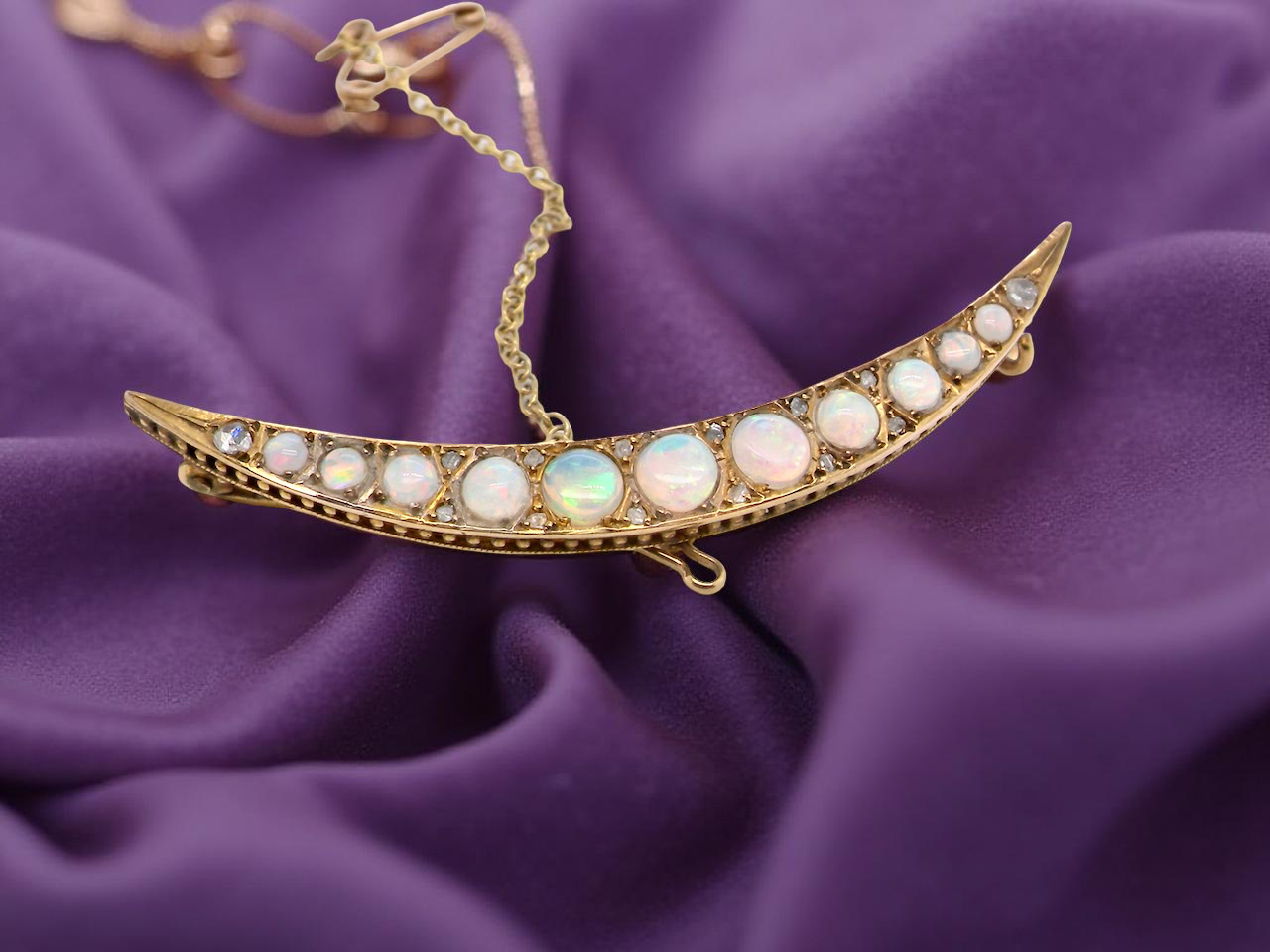 An Edwardian opal crescent shaped brooch