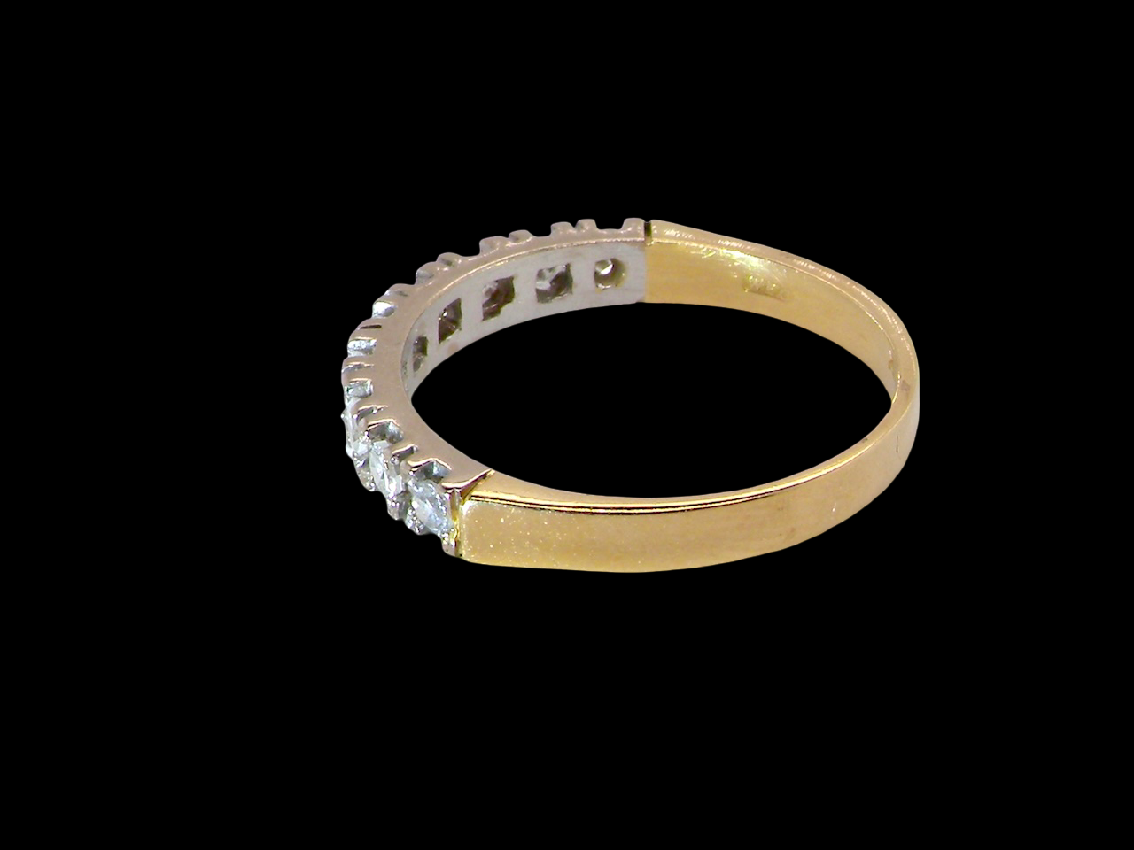 rear  1970s vintage half-hoop eternity ring, tested as 18 carat gold and elegantly set with nine brilliant-cut white diamonds. 