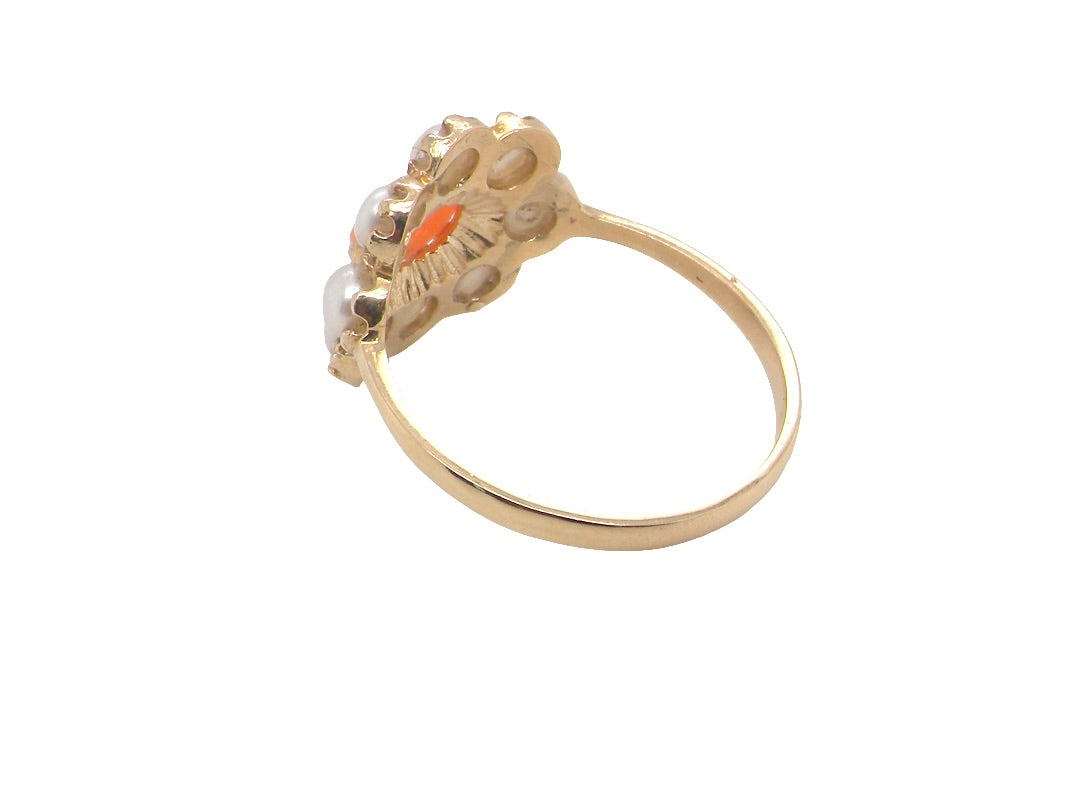 rear A 9 carat gold cluster ring. Centre stone an oval shaped coral stone 6x4mm.
