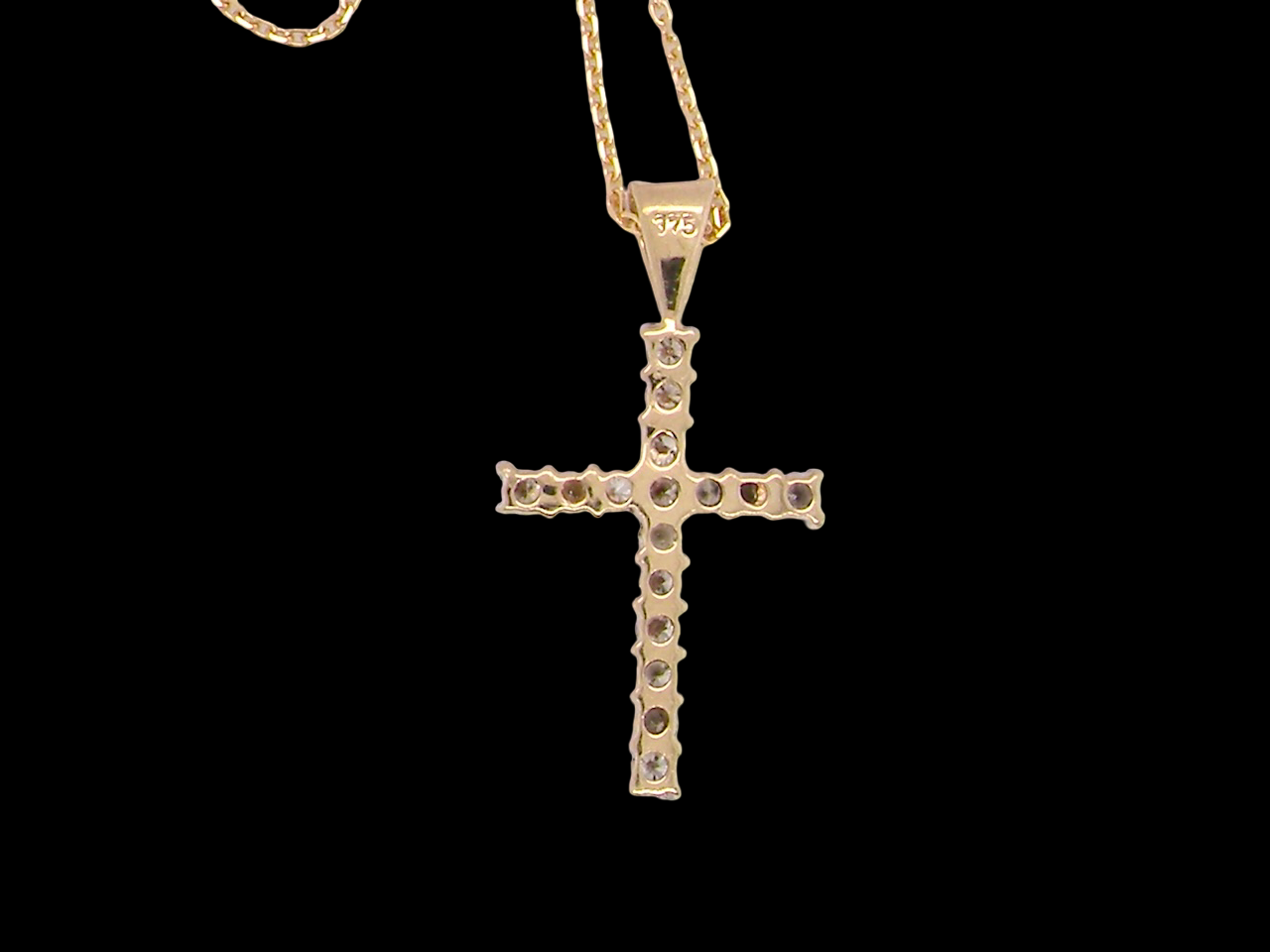 rear A 9 carat gold cross pendant. Set with fifteen small brilliant cut white diamonds.

Each 1.6mm, total carat weight estimated at 0.30 carats. Colour i-k, clarity Si. Overall size 18x12.5mm. Attached to an 18' neck chain.