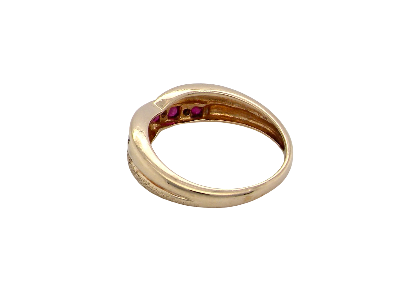 rear A 9 carat gold half hoop eternity ring. Set with five calibre cut rubies, from 1.7 to 2mm, and between small 1mm white diamonds.
