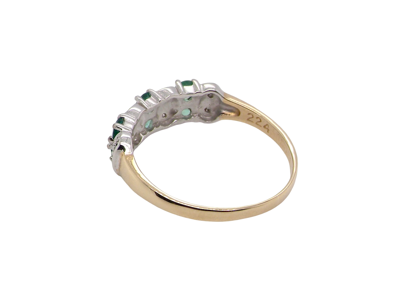 rear A 9 carat gold half hoop ring. Set with six round emeralds 3mm each,(total 0.35 carats est) and interspaced with vertical white gold sections each set with 1mm diamonds.(0.05 carats est)