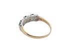rear A 9 carat gold half hoop ring. Set with six round emeralds 3mm each,(total 0.35 carats est) and interspaced with vertical white gold sections each set with 1mm diamonds.(0.05 carats est)