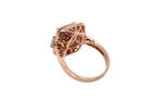 A rose gold filigree ring with a square-cut clear gemstone, shown from a side angle on a plain white background.