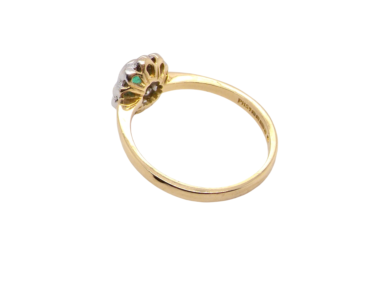 rear A beautifully elegant cluster ring featuring a central oval-cut emerald, measuring 5 x 4mm (estimated 0.40 carats).
