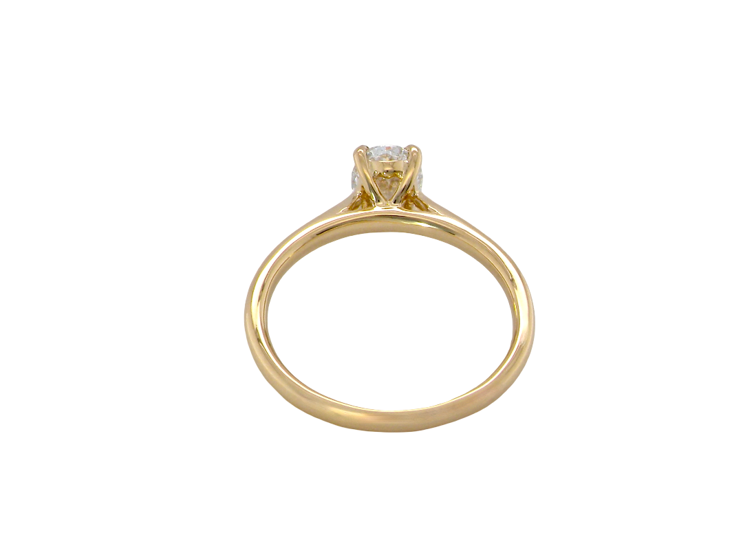 A yellow gold solitaire ring with a single round-cut gemstone in a four-prong setting, shown from a top-down view on a plain white background.