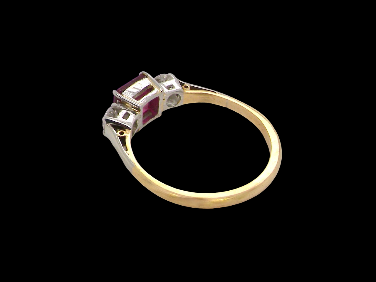 Gold ring with gemstones on a black background