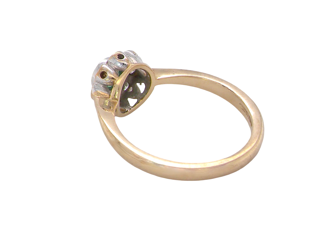 A yellow gold ring with a decorative, multi-pronged setting holding a clear gemstone, shown on a plain white background.