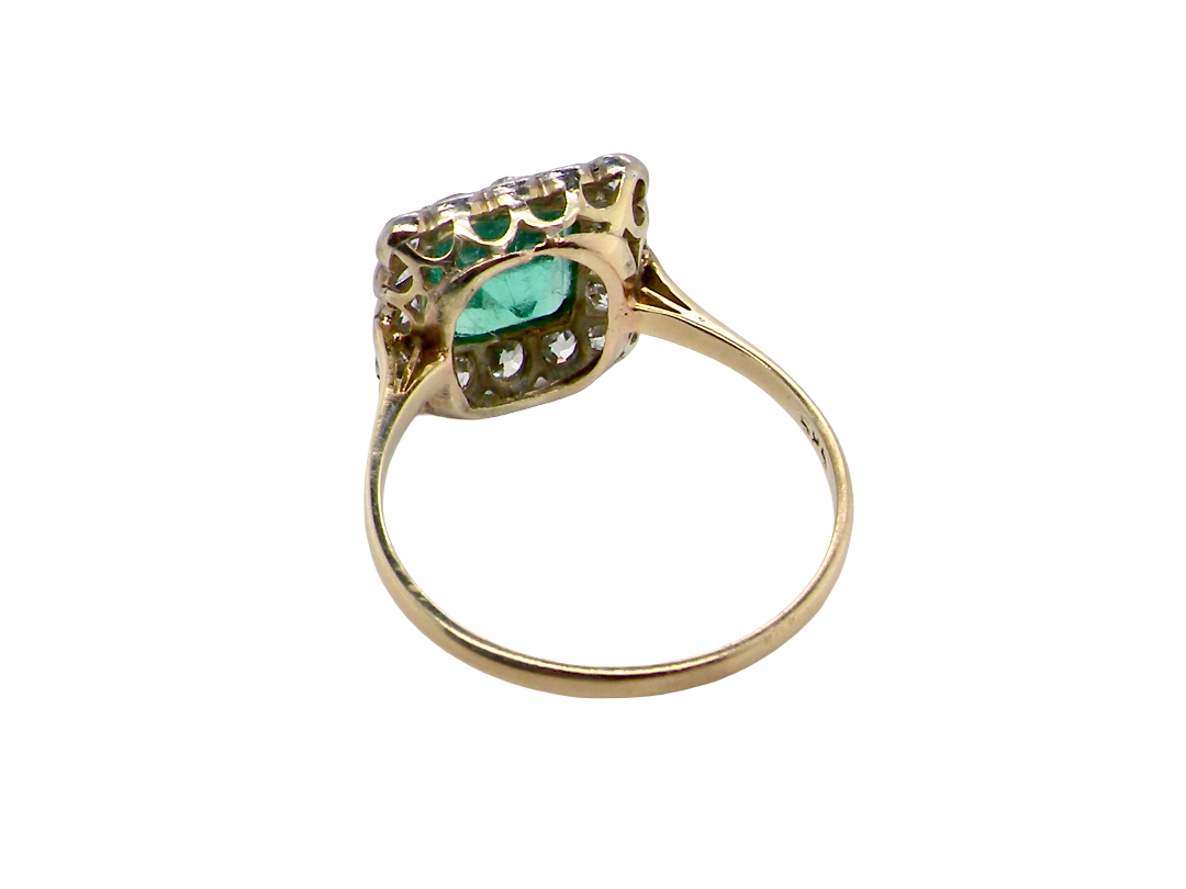 rear A fine Art Deco emerald and diamond cluster ring, beautifully proportioned and displaying all the elegance associated with the period.