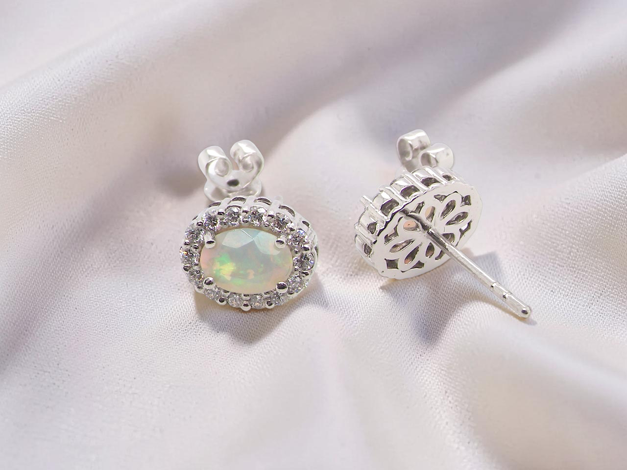 rear A fine and elegant pair of platinum* stud earrings, each beautifully set with an exceptional white opal measuring 7 x 5mm. T