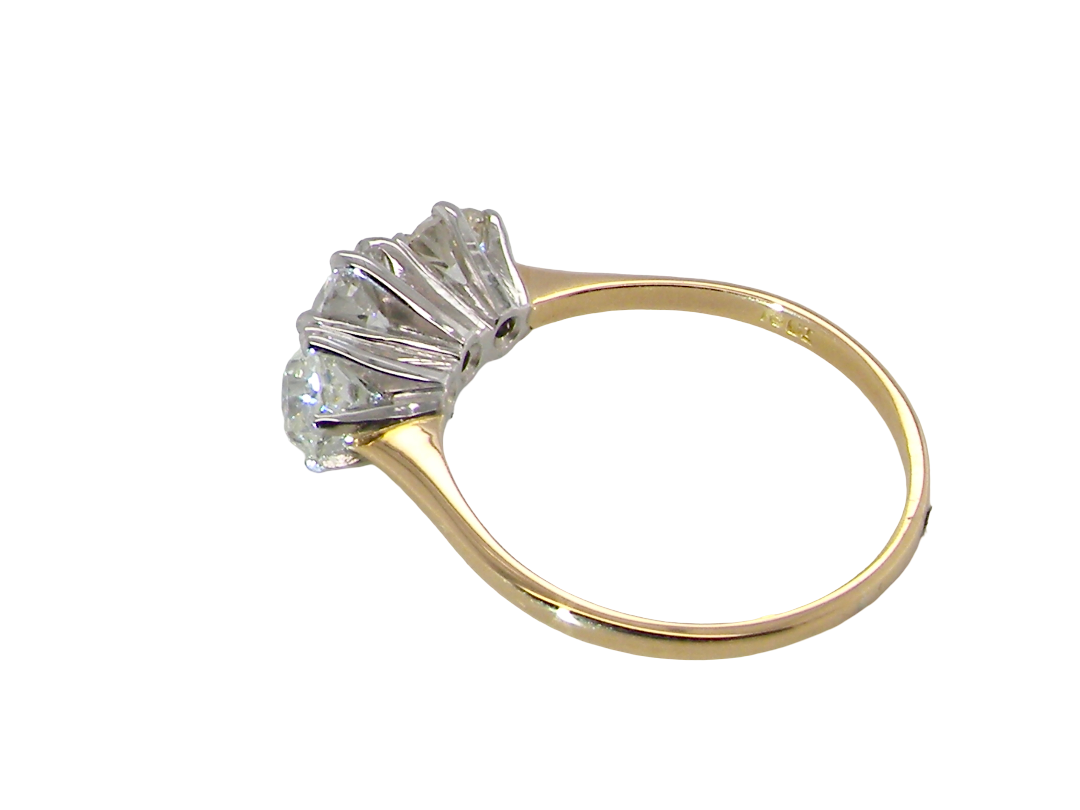 A yellow gold ring with a multi-stone diamond cluster setting, shown on a plain white background.