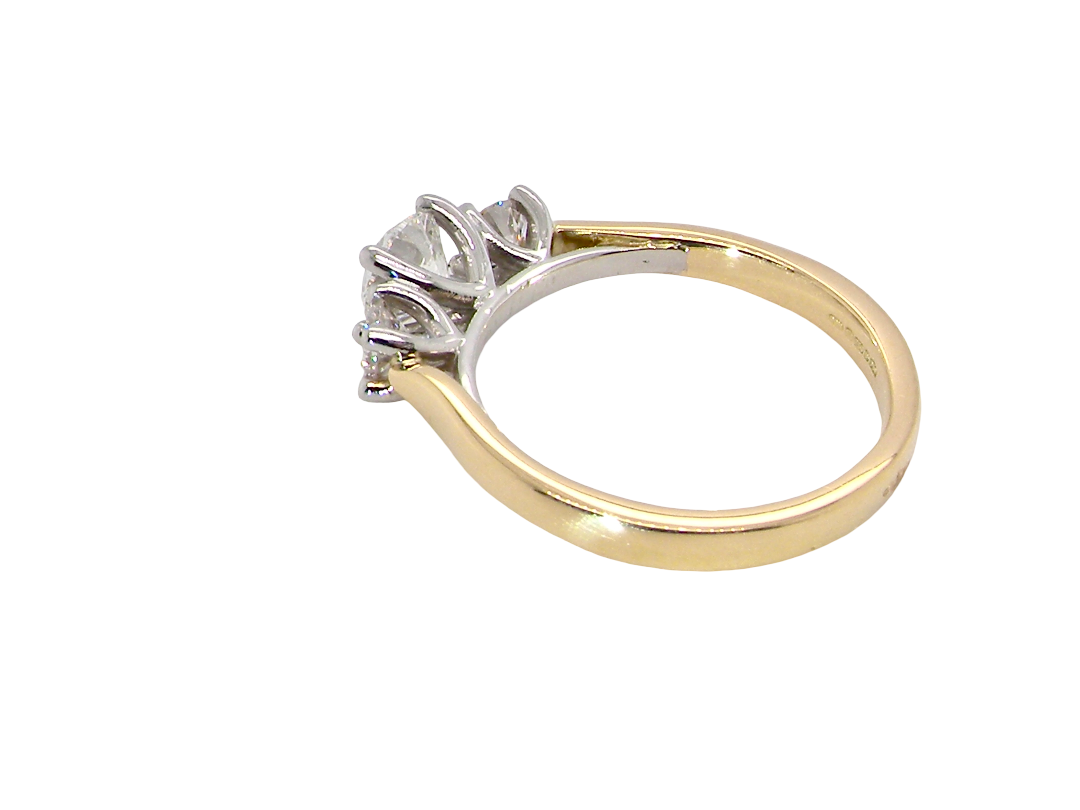 rear A fine and impressive three stone diamond trilogy ring, beautifully set with three graduated brilliant cut white diamonds.