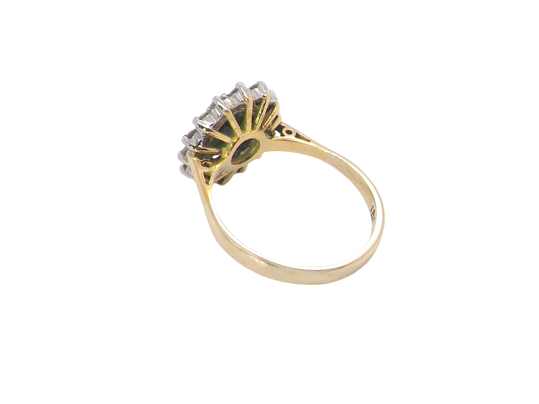 rear A fine and impressive vintage cluster ring, centred with a striking oval-cut deep dark green tourmaline, measuring 9 x 7mm and estimated to weigh approximately 2.00 carats.