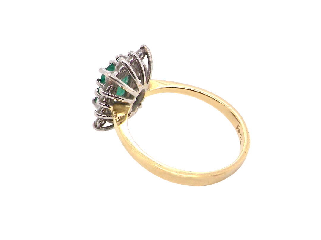 rear A fine cluster ring that features a rectangular mid to dark green emerald, measures 8x6mm (est 0.50 carats)&nbsp;
