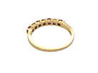 rear A half hoop 18 carat yellow gold eternity ring. Set with four bright red rubies, each 2.6mm (total carat weight 0.28 est)