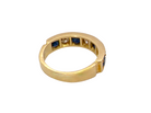 A vintage gold ring with a split shank design, featuring rows of dark blue round sapphires and a central clear stone, shown on a plain white background.