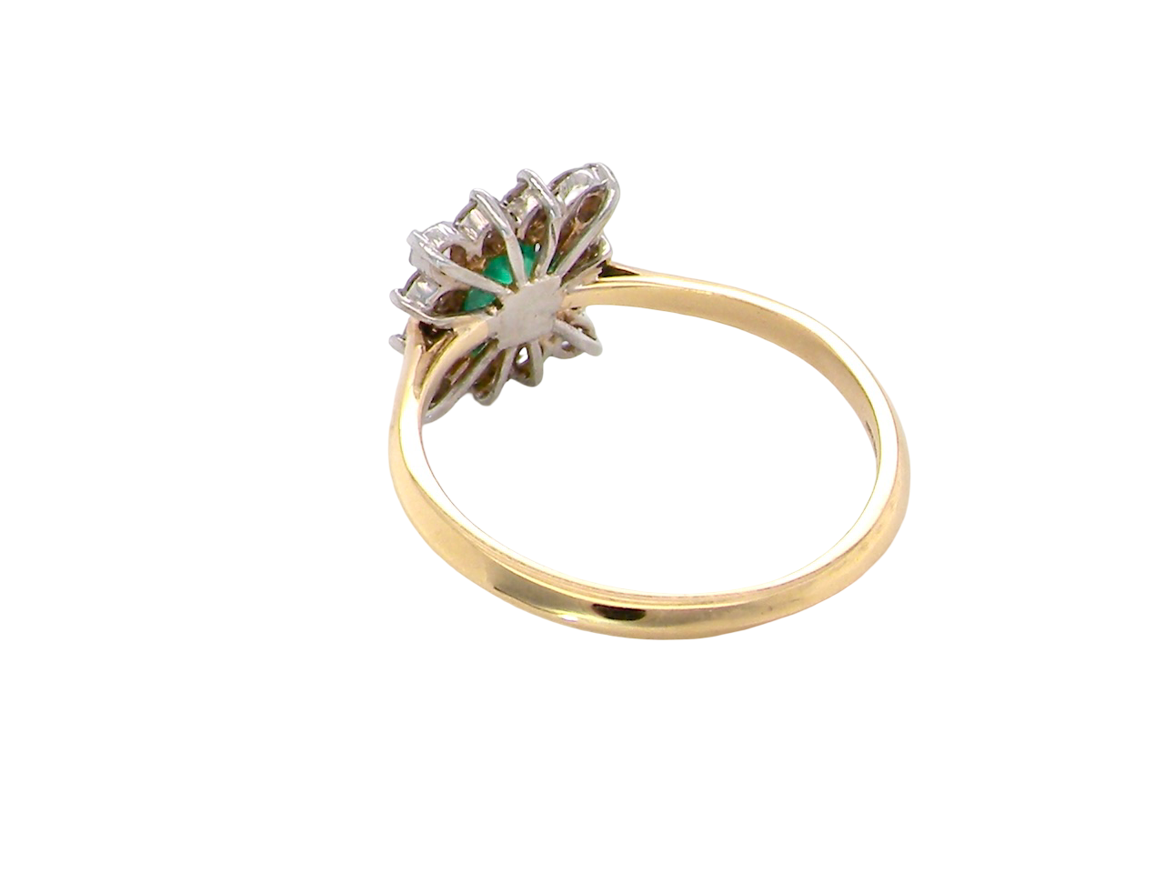 rear A lovely cluster ring that features to the centre a rectangle shaped emerald, 7x5mm. Shows a deep grass green colour which does have natural inclusions common with most emeralds, but the depth of colour is impressive.
