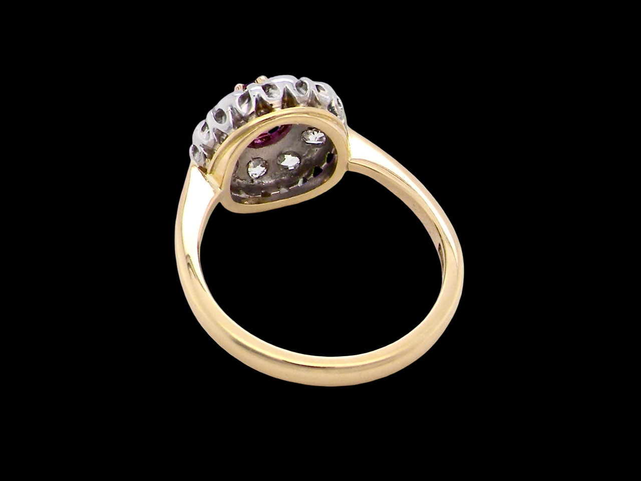 rear A lovely daisy cluster ring that profiles to the centre a deep red ruby, 5mm (0.50 carats) yellow claw set.
