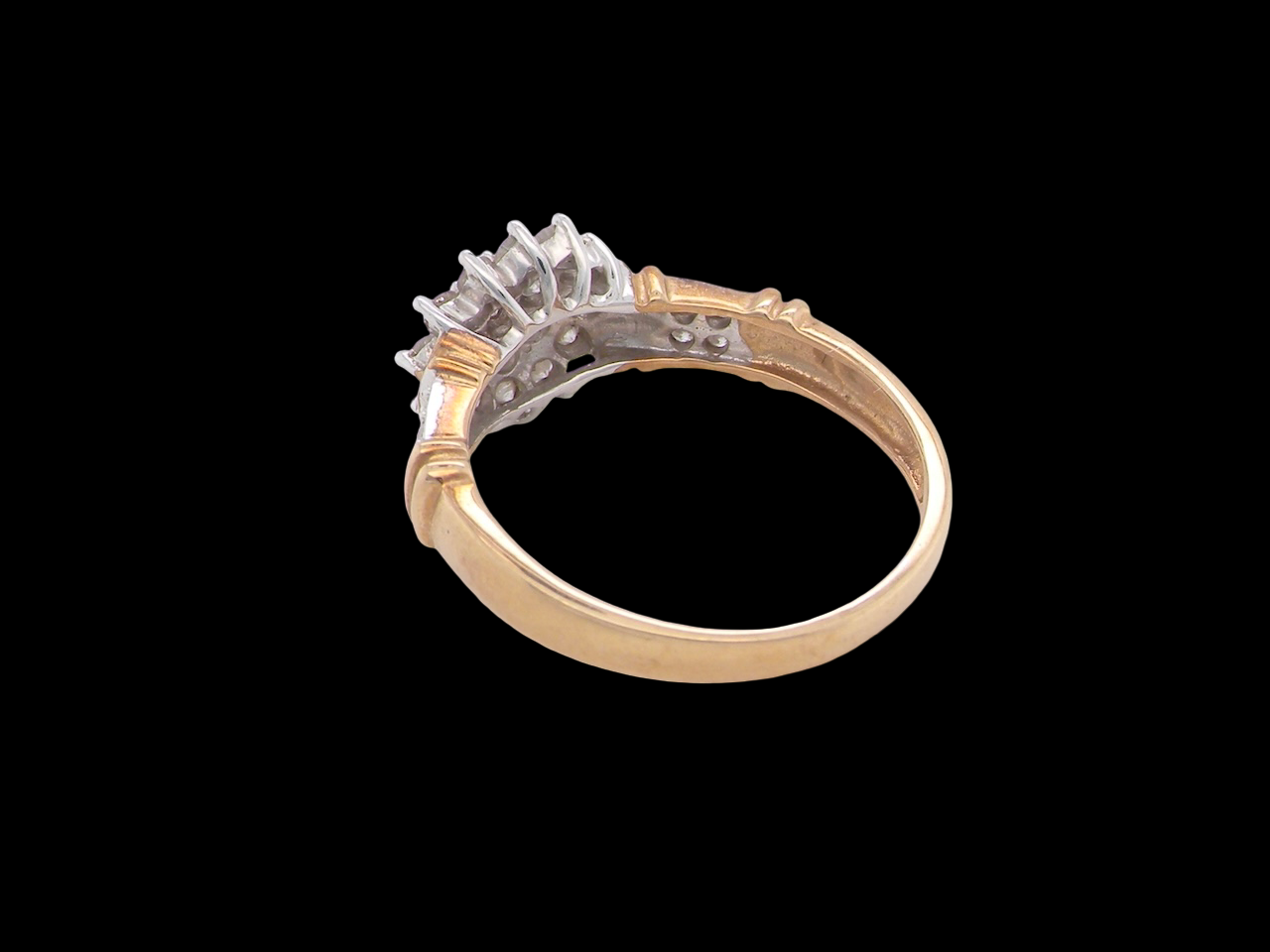 rear A modern 9 carat gold cluster ring featuring a round head fully set with nineteen brilliant-cut white diamonds,