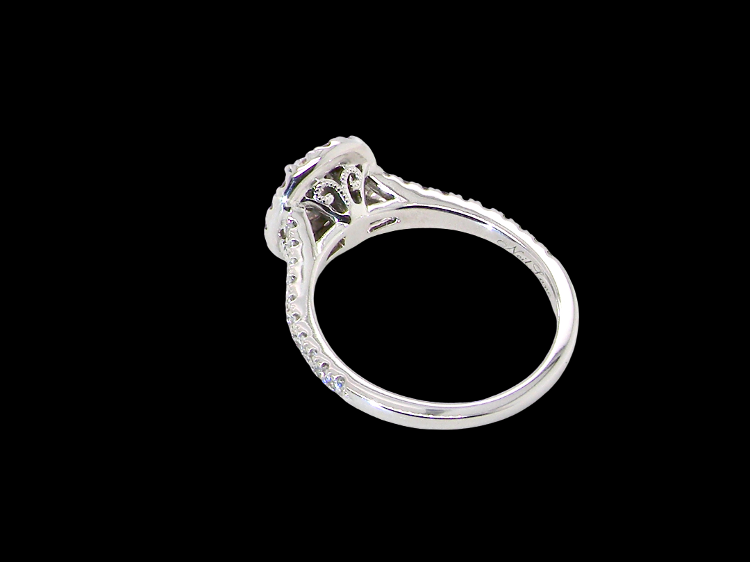 rear A new diamond cluster ring* An oval diamond halo cluster ring. Set with brilliant cut white diamonds, colour H-k, clarity Si.