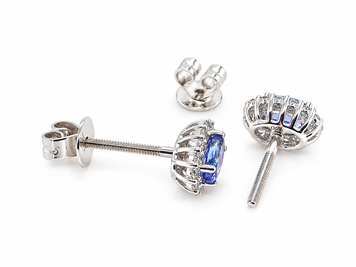 rear A pair of 18 carat white gold cluster earrings.&nbsp;

Features an oval tanzanite gemstone,