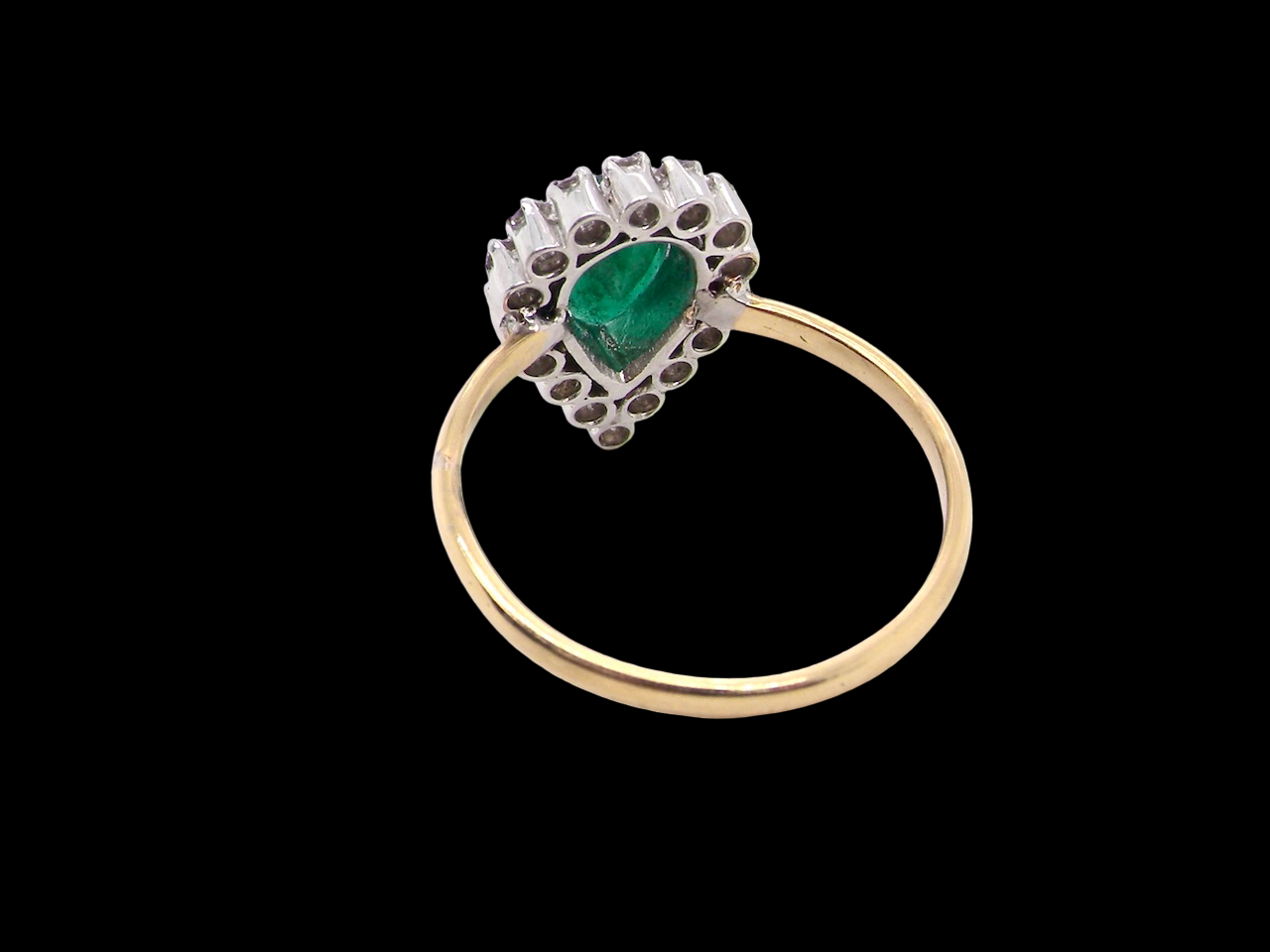 A pear shaped Emerald and Diamond cluster ring