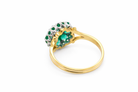 rear A pretty cluster ring that features to the centre a round emerald