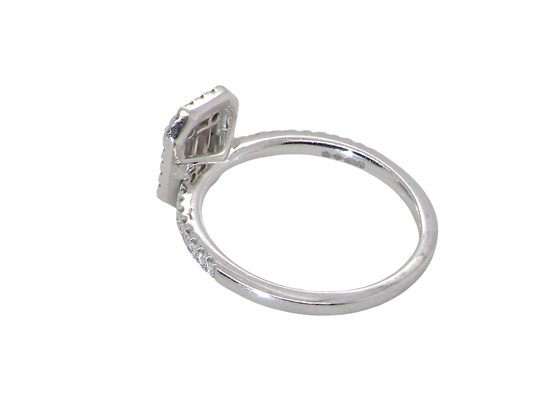rear A rectangular diamond cluster ring. Centre portion is set with three baguette cut white diamonds 3x1.6mm and six mixed cut diamonds 2mm each.&nbsp;

Surrounded by a halo of twenty two small round diamonds