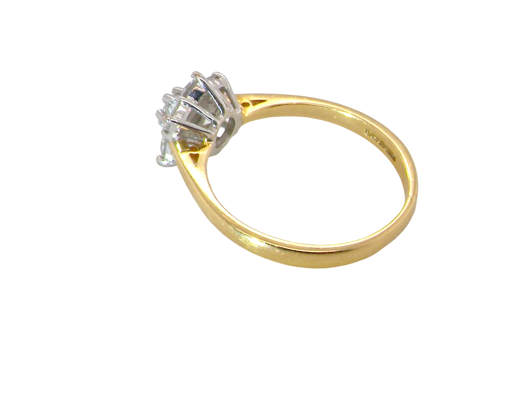 rear A small cluster ring set with seven bright white brilliant cut white diamonds.

Head measures 8.5mm, each diamond measures 2.8mm (total 0.50 carats