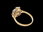 rear A striking vintage sapphire and diamond cluster ring dating from the 1930s–1940s, beautifully crafted in platinum and 18 carat gold. At the centre sits a richly coloured oval-cut sapphire of deep inky blue-black hue, measuring approximately 7 x 5mm and estimated at 0.75 carats.