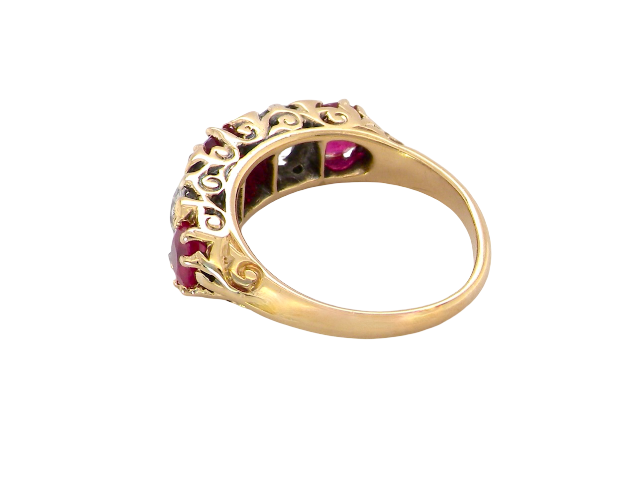rear A superb Victorian ring, carved boat shaped head. Set with three fine rubies , 